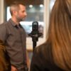 man and woman in front of microphone