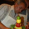 Man making a fruit sculpture as a team building activity