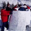 Group of people making an igloo as a team building activity with My Studio Party
