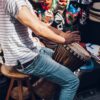 Man sitting and drumming a rhythm