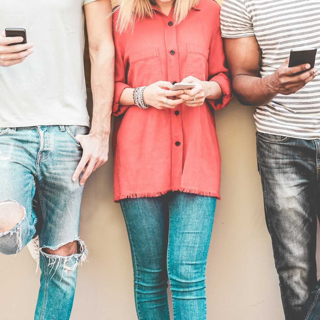 group of millennials watching smart mobile phones