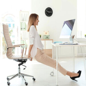 Woman in the office performning yoga with her office chair as a yoga prop