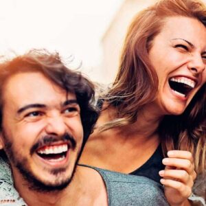 Man and woman laughing and smiling together on a sunny day | Icebreaker and Creative Games | Icebreakers and Creative Games