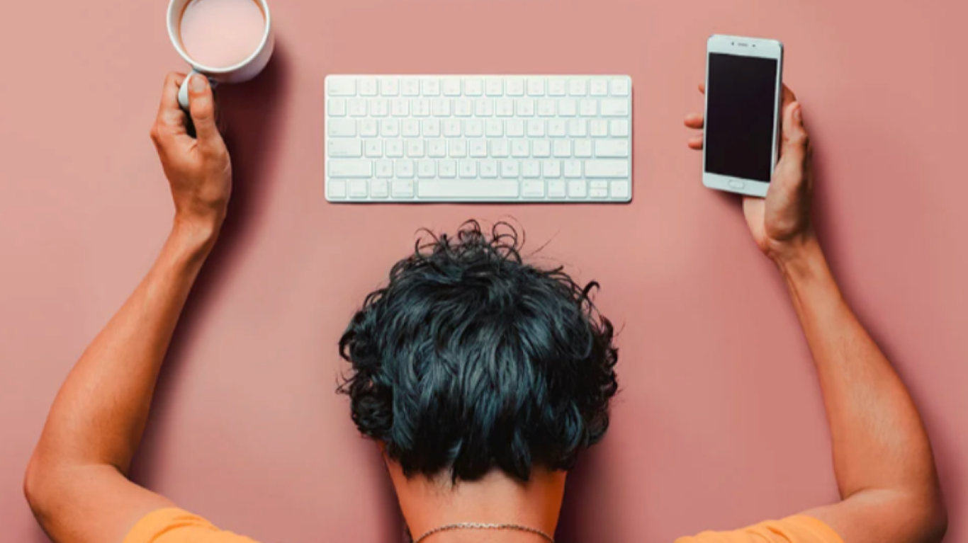 Leader overwhelmed by constant notifications and tasks, illustrating the brain’s dopamine-driven addiction to busyness and mental overload.